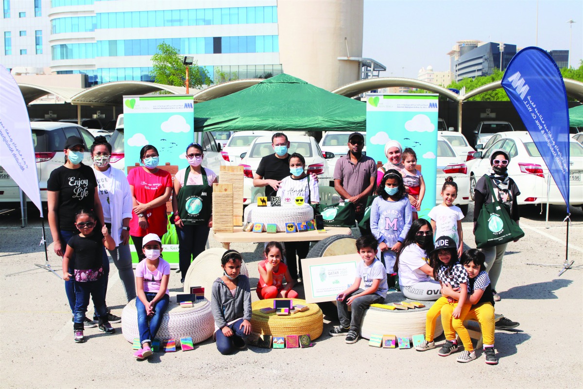 Officials from AAB and community members with upcycled items during an event to mark QSW.