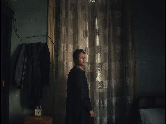 A screenshot from the film 'I Am Afraid To Forget Your Face'.