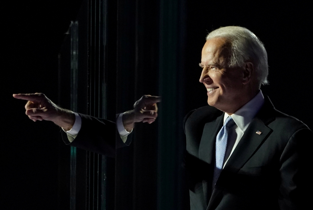 FILE PHOTO: President-elect Joe Biden points a finger at his election rally in Wilmington, Delaware, November 7. REUTERS/Kevin Lamarque