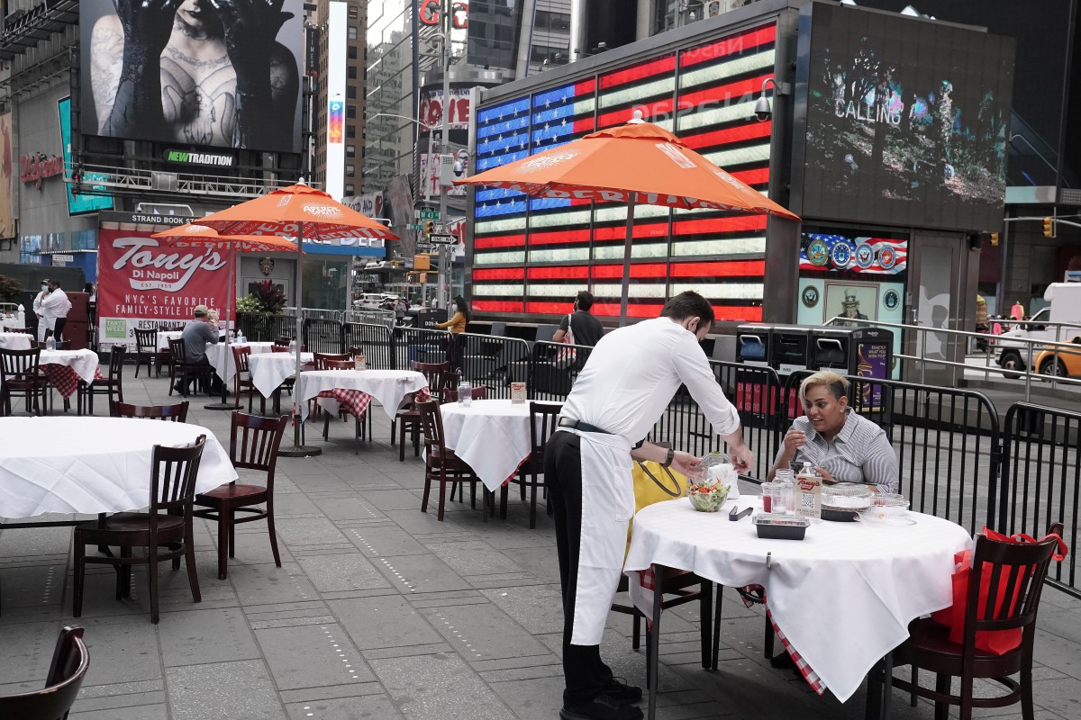 FILE PHOTO: Servers package food at a table at a pop up restaurant set up in Times Square for 'Taste of Times Square Week' during the coronavirus disease (COVID-19) pandemic in the Manhattan borough of New York City, New York, U.S., October 23, 2020. REUT