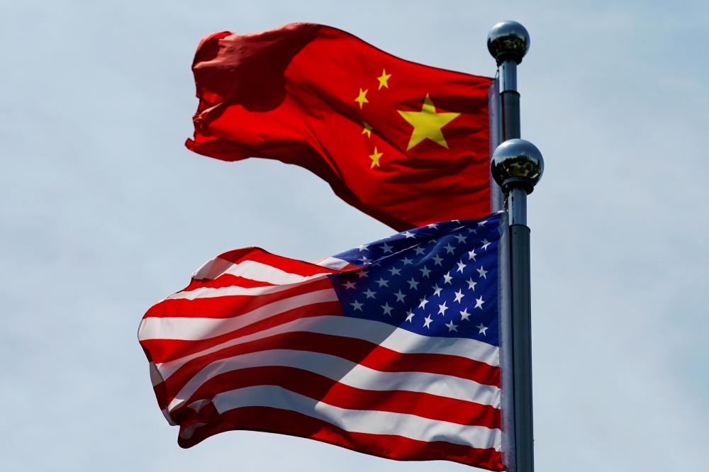 FILE PHOTO: Chinese and U.S. flags flutter near The Bund, before U.S. trade delegation meet their Chinese counterparts for talks in Shanghai, China July 30, 2019. REUTERS/Aly Song/File Photo