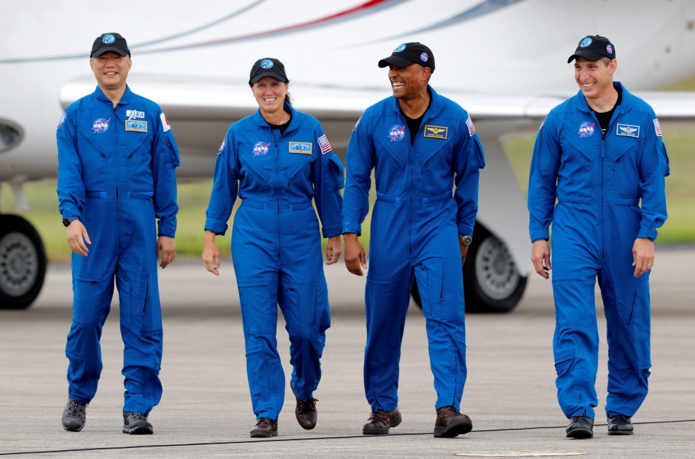 NASA astronauts Shannon Walker, Victor Glover, Mike Hopkins, and JAXA (Japan Aerospace Exploration Agency) astronaut Soichi Noguchi, who comprise Crew-1, walk at Kennedy Space Center ahead of the NASA/SpaceX launch of the first operational commercial crew