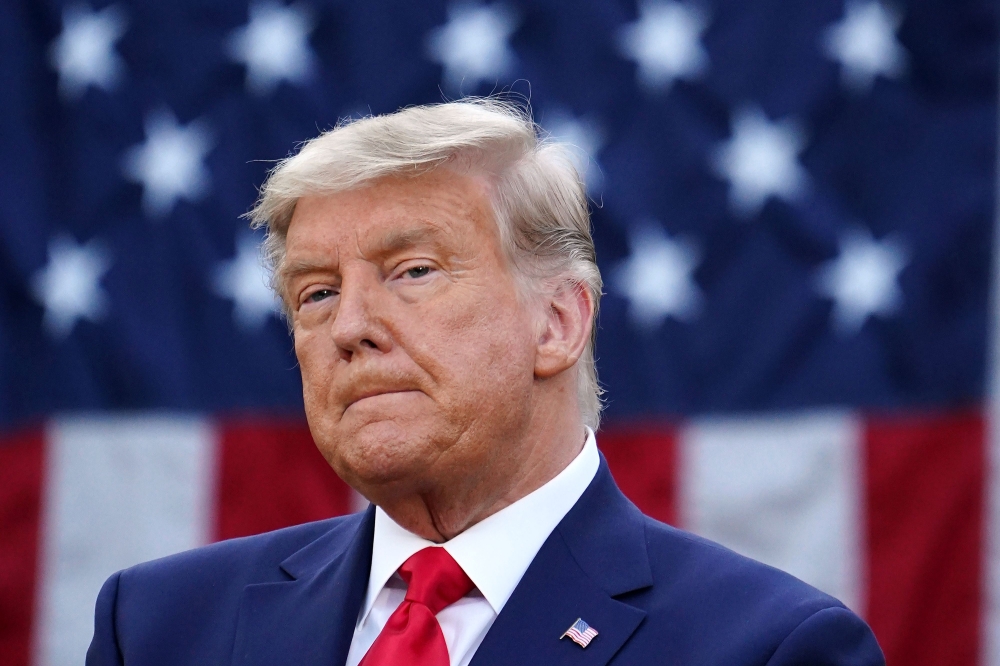 US President Donald Trump looks on after delivering an update on 