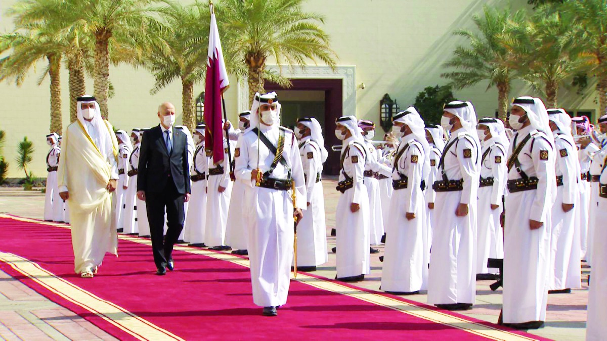 Amir H H Sheikh Tamim bin Hamad Al Thani and President of the Republic of Tunisia, H E Kais Saied, inspecting a guard of honour at the Amiri Diwan yesterday.