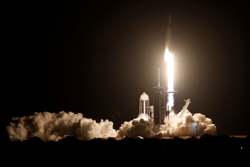 A SpaceX Falcon 9 rocket, with the Crew Dragon capsule, is launched carrying four astronauts on the first operational NASA commercial crew mission at Kennedy Space Center in Cape Canaveral, Florida, U.S. November 15, 2020. REUTERS/Thom Baur