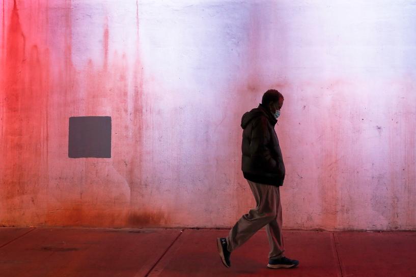 A man wearing a protective face mask, as the global outbreak of the coronavirus disease (COVID-19) continues, walks under a bridge in Yonkers, New York, U.S., November 17, 2020. REUTERS/Shannon Stapleton/Files
