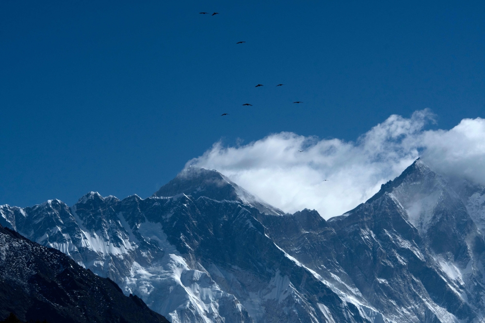 This file photo taken on March 26, 2020 shows Mount Everest (height 8,848 metres) from Namche Bazaar, the last stop before base camp in the shadow of the world's tallest mountain Everest. / AFP / PRAKASH MATHEMA