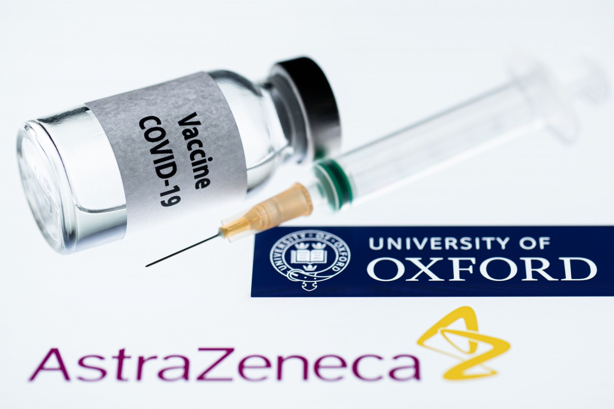 This illustration picture taken in Paris on November 23, 2020 shows a syringe and a bottle reading 