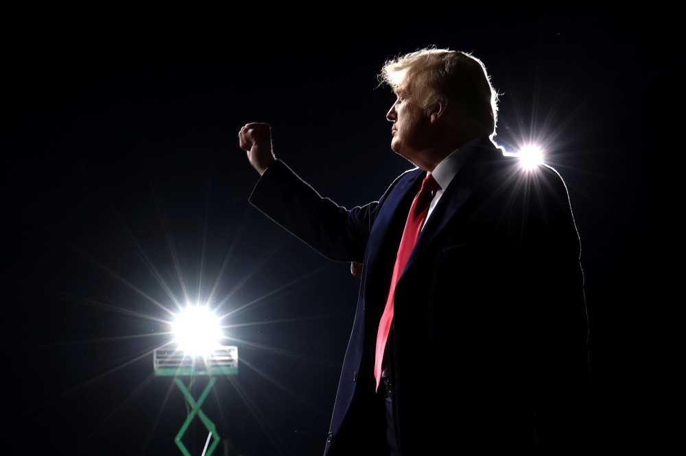 U.S. President Donald Trump gestures as he departs after a campaign event for Republican U.S. senators David Perdue and Kelly Loeffler in Valdosta, Georgia, U.S., December 5, 2020. REUTERS/Jonathan Ernst