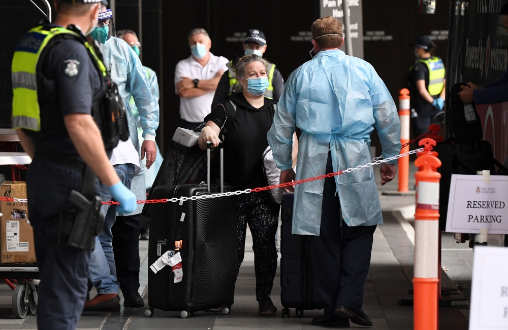 Travellers arrive at a hotel in Melbourne on December 7, 2020 where Australians returning from overseas will quarantine as part of precautions against the Covid-19 coronavirus. An outbreak of the coronavirus from hotel quarantine earlier in the year from 