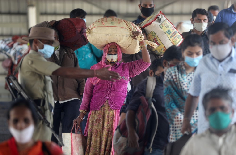 A policeman directs crowd at a railway station amidst the spread of the coronavirus disease (COVID-19) in Mumbai, India, December 4, 2020. Reuters/Francis Mascarenhas