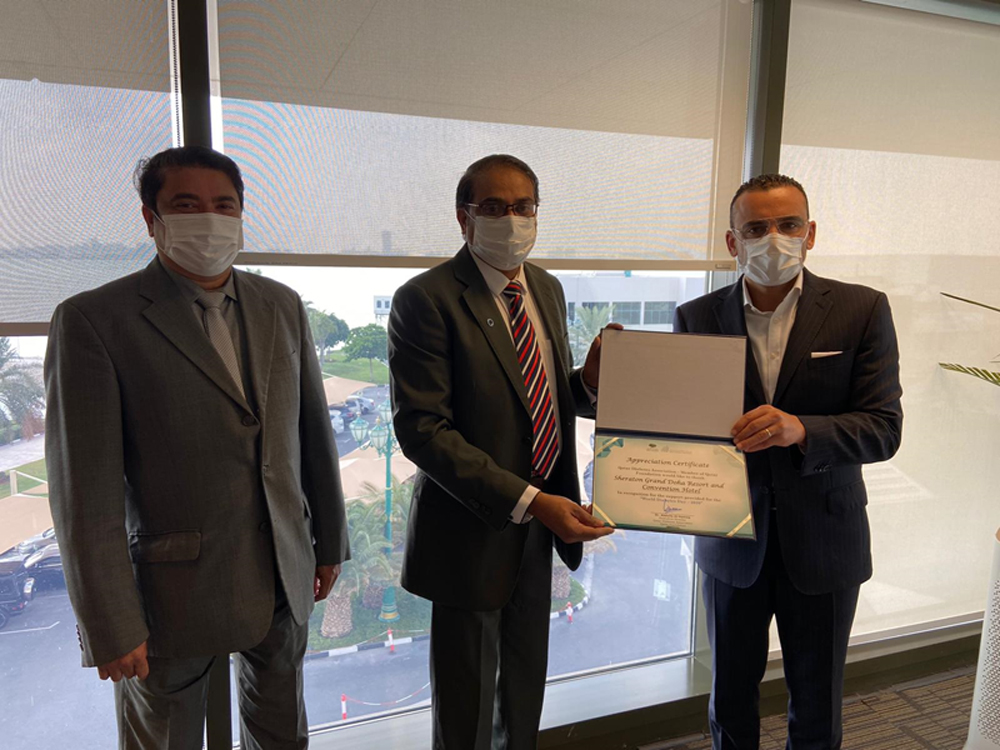 Qatar Diabetes Association representative Ashraf PV (centre) handing over the certificate of appreciation to Sheraton Doha Resort and Convention Hotel general manager Belal Alkadry.