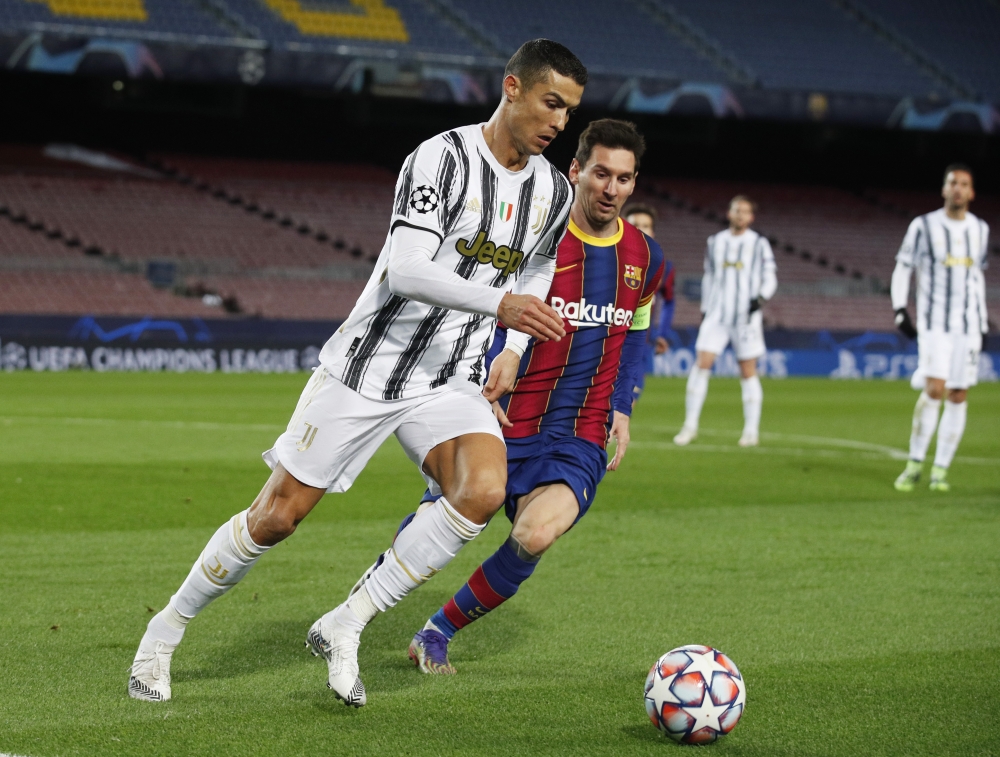 December 8, 2020 FC Barcelona's Lionel Messi in action with Juventus' Cristiano Ronaldo REUTERS/Albert Gea
