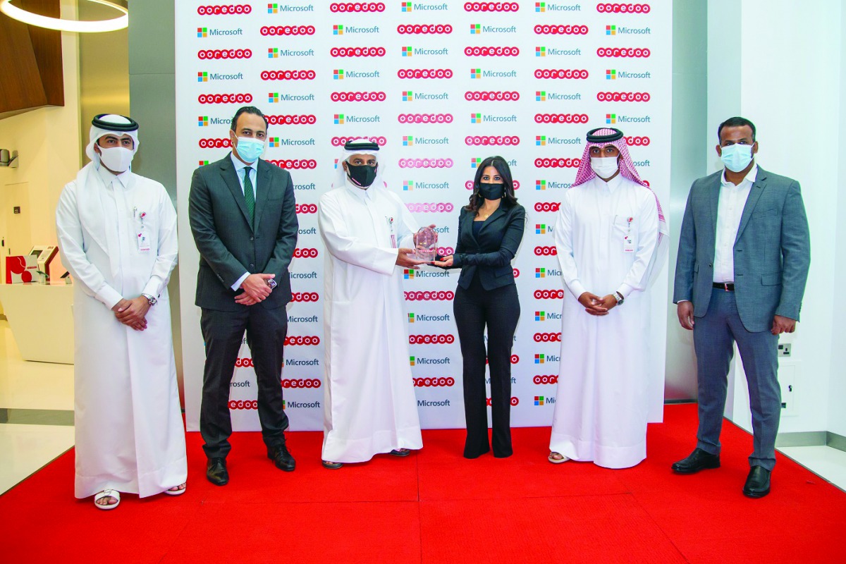 Ooredoo and Microsoft officials during a ceremony.
