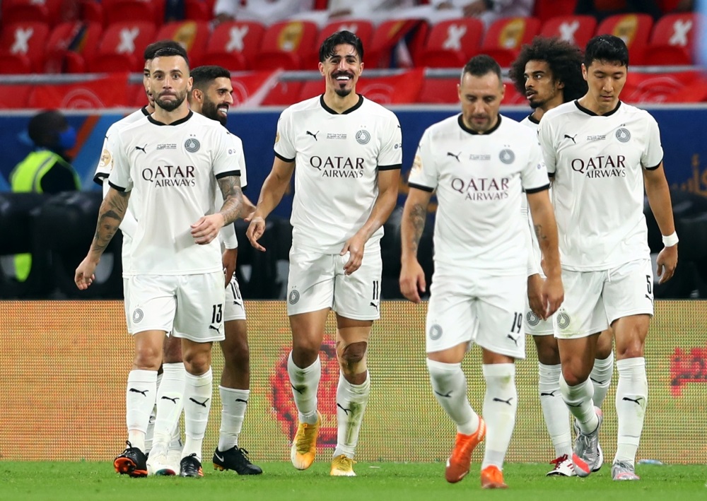 Al Sadd's Baghdad Bounedjah celebrates scoring their second goal with teammates. (Reuters/Ibraheem Al Omari)