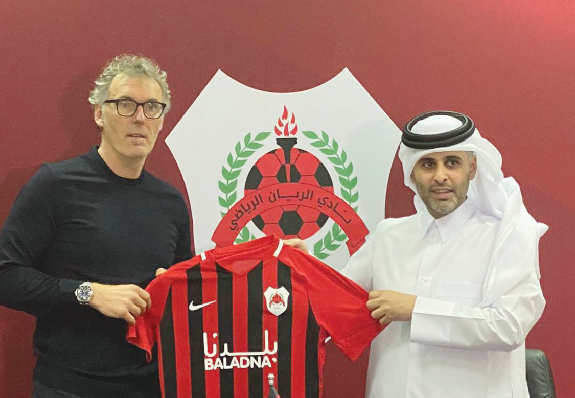 Al Rayyan's new French coach Laurent Blanc receiving a team jersey from Sheikh Ali bin Saud Al Thani yesterday.