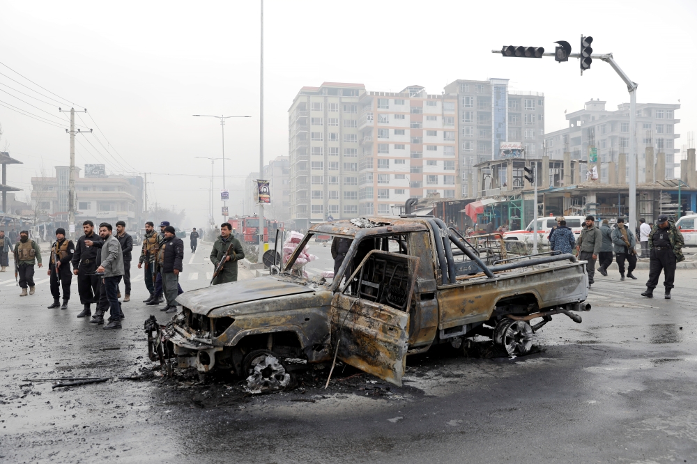 Afghan policemen inspect at the site of a blast in Kabul, Afghanistan December 20, 2020. REUTERS/Mohammad Ismail