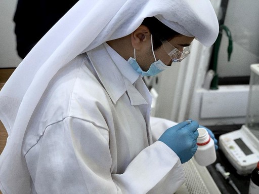 A student of QU Young Scientist Center working in a laboratory.  