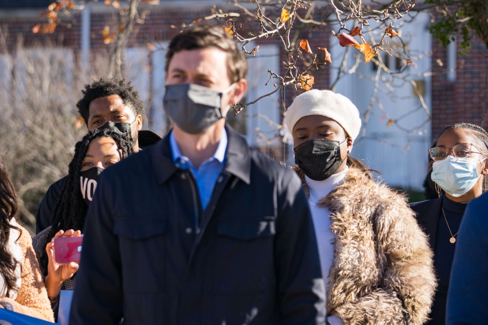 Georgia Democratic Senate candidate Jon Ossoff listens to community members before voting early at the Metropolitan Library on December 22, 2020 in Atlanta, Georgia. (Megan Varner/Getty Images/AFP)