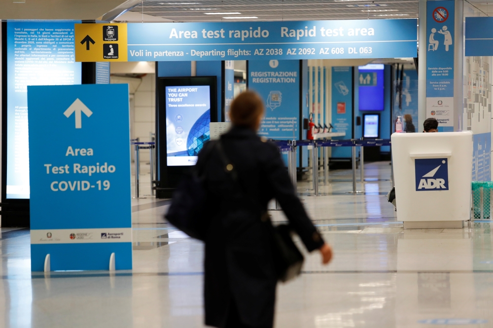 A person walks near of a COVID-19 test area at Fiumicino airport after the Italian government announced flights to and from the UK will be resumed following an order by the Health Ministry, amid the spread of the coronavirus disease (COVID-19), in Rome, I