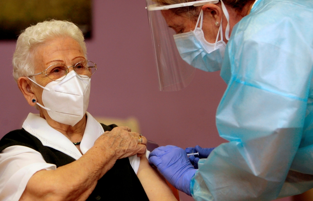 Los Olmos nursing home resident Araceli, 96, receives the first injection nationwide, with a dose of Pfizer-BioNTech COVID-19 vaccine, as the coronavirus disease (COVID-19) outbreak continues, in Guadalajara, Spain, December 27, 2020. Pepe Zamora/Pool via