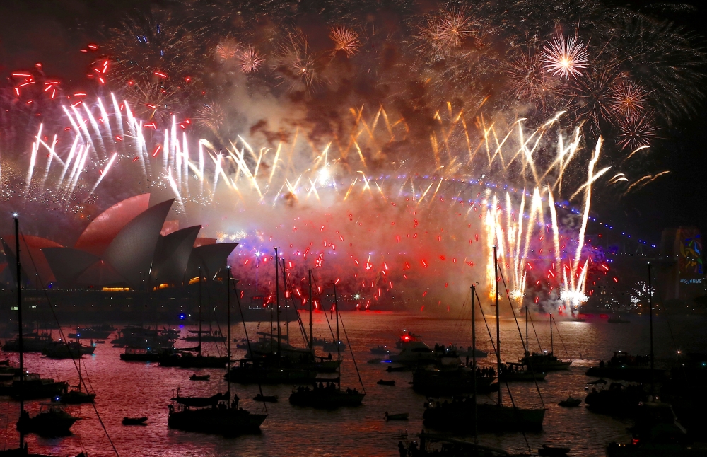 Fireworks light up the Sydney Harbour Bridge and Sydney Opera House during new year celebrations on Sydney Harbour, Australia, January 1, 2018. REUTERS/David Gray/File Photo