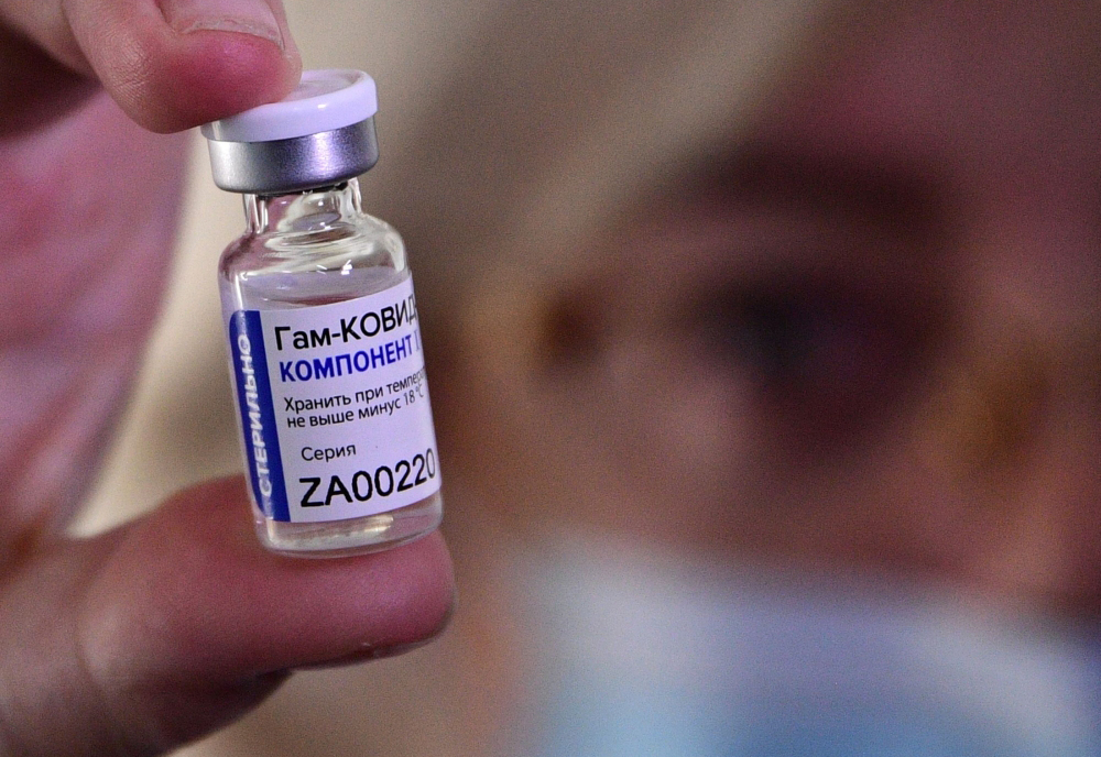 FILE PHOTO: In this file photo taken on December 14, 2020, a medical worker shows a vial with Sputnik V (Gam-COVID-Vac) vaccine against the coronavirus disease during the vaccination of medics at a clinic in the far eastern city of Vladivostok.  AFP / Pav