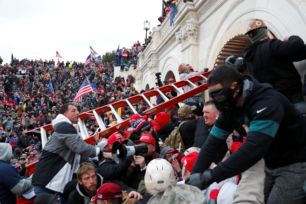 Pro-Trump protesters storm into the US Capitol during clashes with police, during a rally to contest the certification of the 2020 US presidential election results by the US Congress, in Washington, US, January 6, 2021. Reuters/Shannon Stapleton