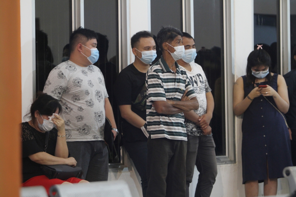 Family of a Sriwijaya Air passenger wait after Flight SJ182, with over 60 people on board, lost contact. Antara Foto/Jessica Helena Wuysang via Reuters