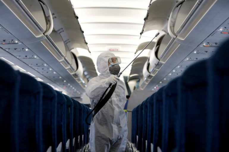 A health worker sprays disinfectant inside a Vietnam Airlines airplane to protect from the recent coronavirus outbreak, at Noi Bai airport in Hanoi, Vietnam February 21, 2020. REUTERS/Kham/File Photo