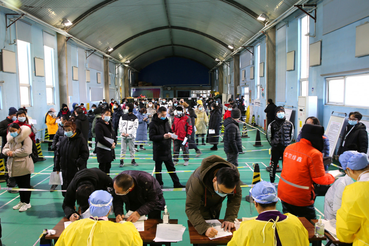 People line up to receive the vaccine against the coronavirus disease (COVID-19) at a makeshift vaccination site inside a sports centre in Beijing's Haidian district, China January 8, 2021. cnsphoto via REUTERS