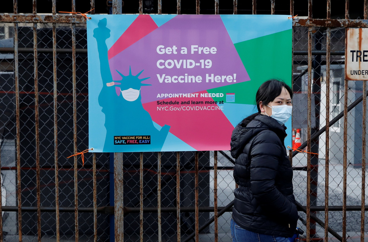 A woman arrives to line up to receive a dose of the coronavirus disease (COVID-19) vaccine at a 24 hour vaccination center at the Brooklyn Army Terminal in Brooklyn, New York, U.S., January 11, 2021. REUTERS/Brendan McDermid
