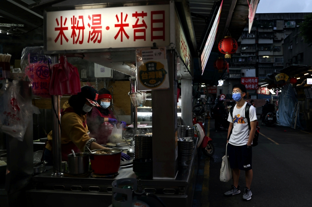 A customer wearing a protective mask, amid the coronavirus disease pandemic, waits for his order at a market in Taipei, Taiwan, January 6, 2021. Reuters/Ann Wang/File Photo