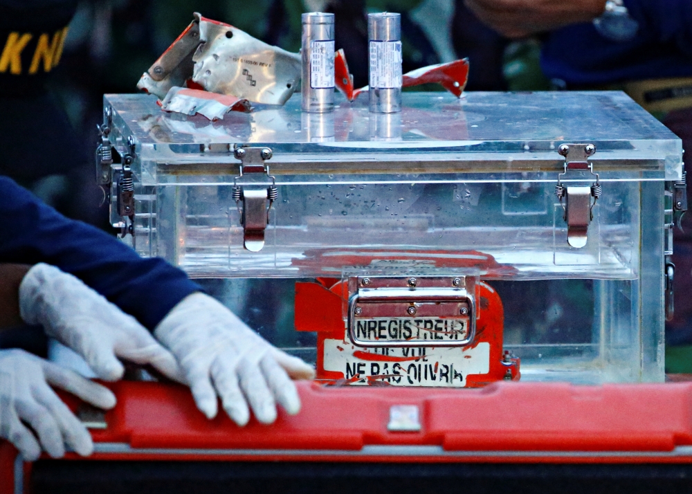 A National Transportation Safety Committee (KNKT) official holds a part of the retrieved black box of Sriwijaya Air flight SJ 182, which crashed into the sea at the weekend off the Jakarta coast, in Jakarta, Indonesia, January 12, 2021. REUTERS/Ajeng Dina