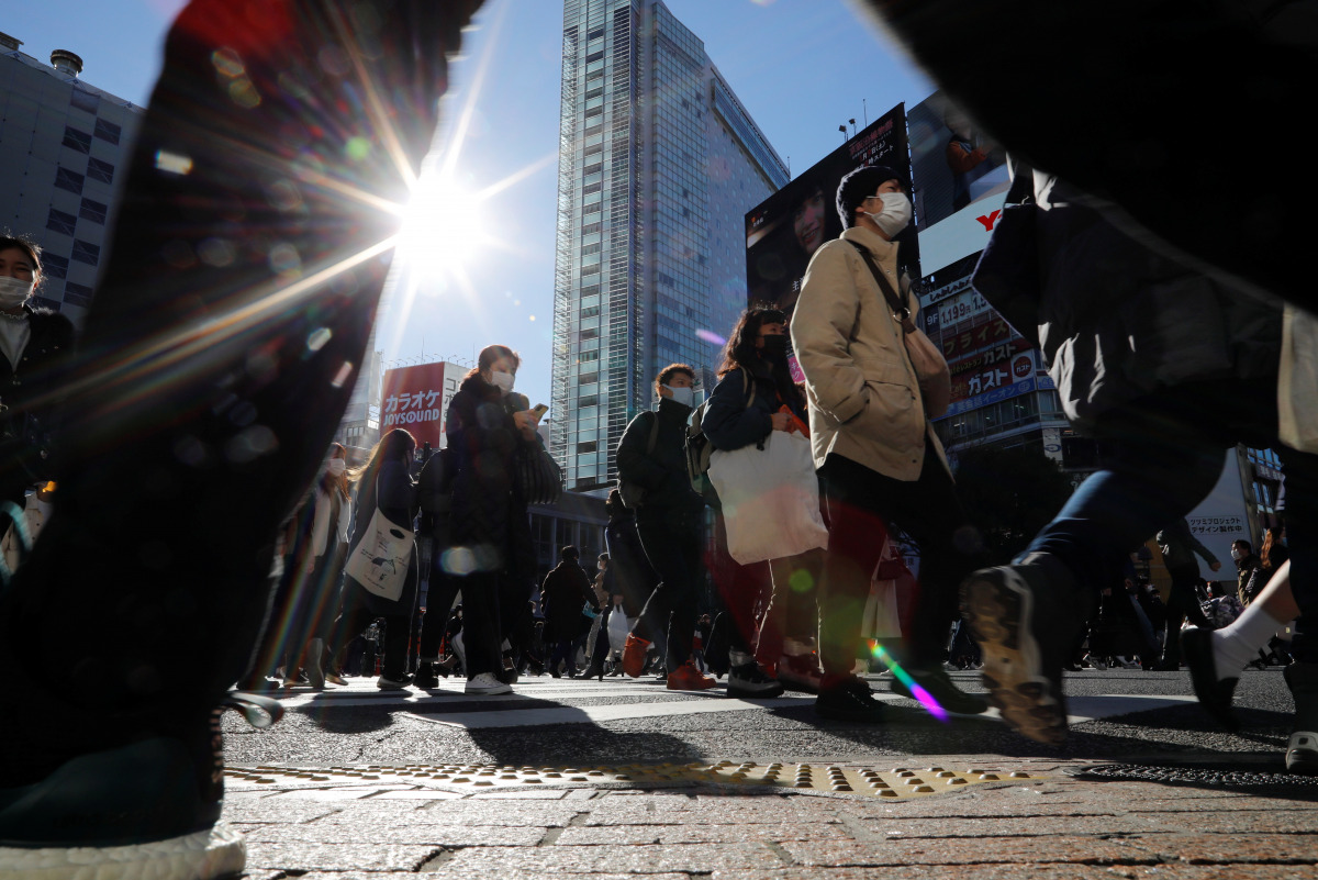 Passersby wearing protective face masks walks at Shibuya crossing after the government declared the second state of emergency for the capital and some prefectures, amid coronavirus disease (COVID-19) outbreak, in Tokyo, Japan January 9, 2021. REUTERS/Isse
