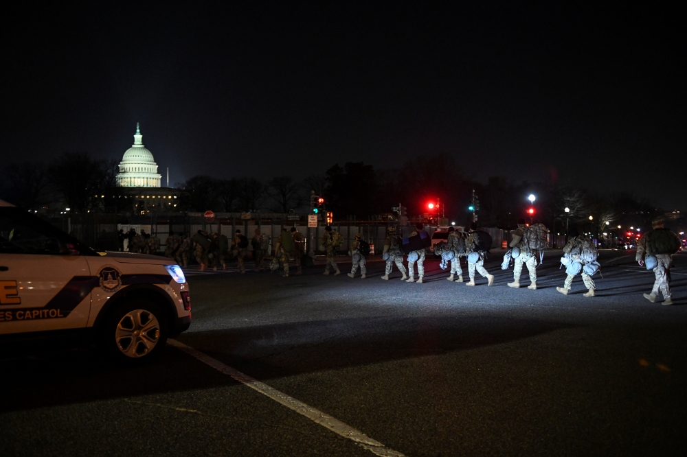 Members of the US National Guard enter the perimeter of the US Capitol in Washington, US January 13, 2021. Reuters/Brandon Bell
