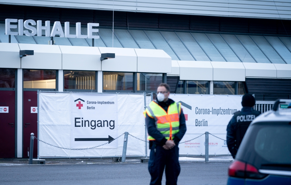 Police guards a vaccination centre temporarily set up at the Erika-Hess ice stadium, amid the spread of the coronavirus disease (COVID-19), in Berlin, Germany, January 14, 2021. Kay Nietfeld/Pool via Reuters 