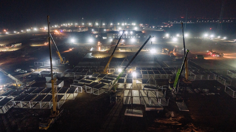 A general view shows cranes and workers at the construction site of a centralised quarantine facility at Guying village, following a recent coronavirus disease (COVID-19) outbreak in Shijiazhuang, Hebei province, China January 14, 2021. China Daily via Re