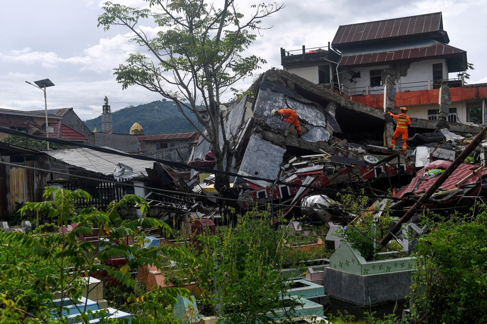 Search and rescue personnel inspect a collapsed building following an earthquake in Mamuju, West Sulawesi province, Indonesia, January 16, 2021. Sigid Kurniawan/Antara Foto via REUTERS/File Photo