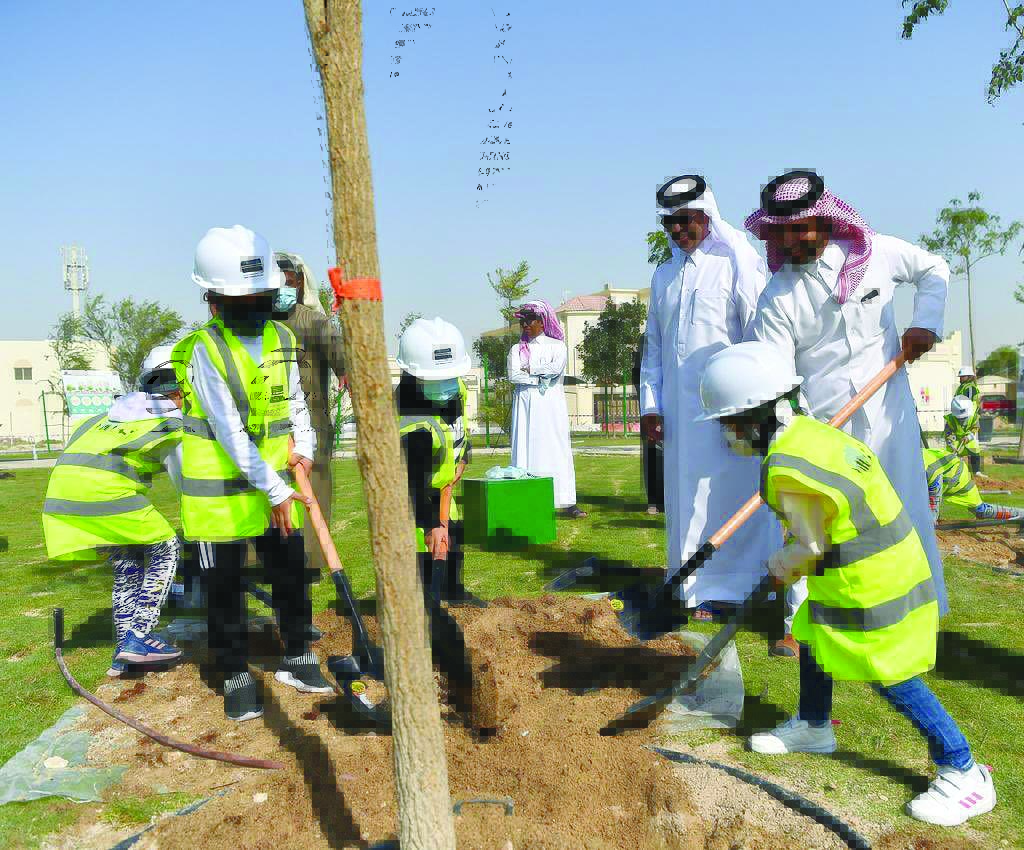 Officials from the Ministry of Municipality and Environment and children from the locality during a tree planting activity at Al Ebb Park yesterday. 