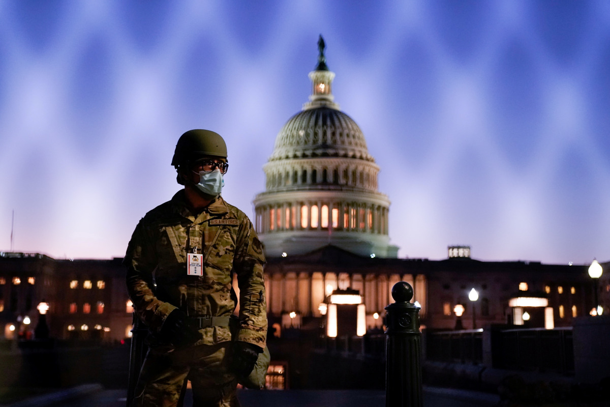 FILE PHOTO: Members of the National Guard gather at the U.S. Capitol as the House of Representatives prepares to begin the voting process on a resolution demanding U.S. Vice President Pence and the cabinet remove President Trump from office, in Washington
