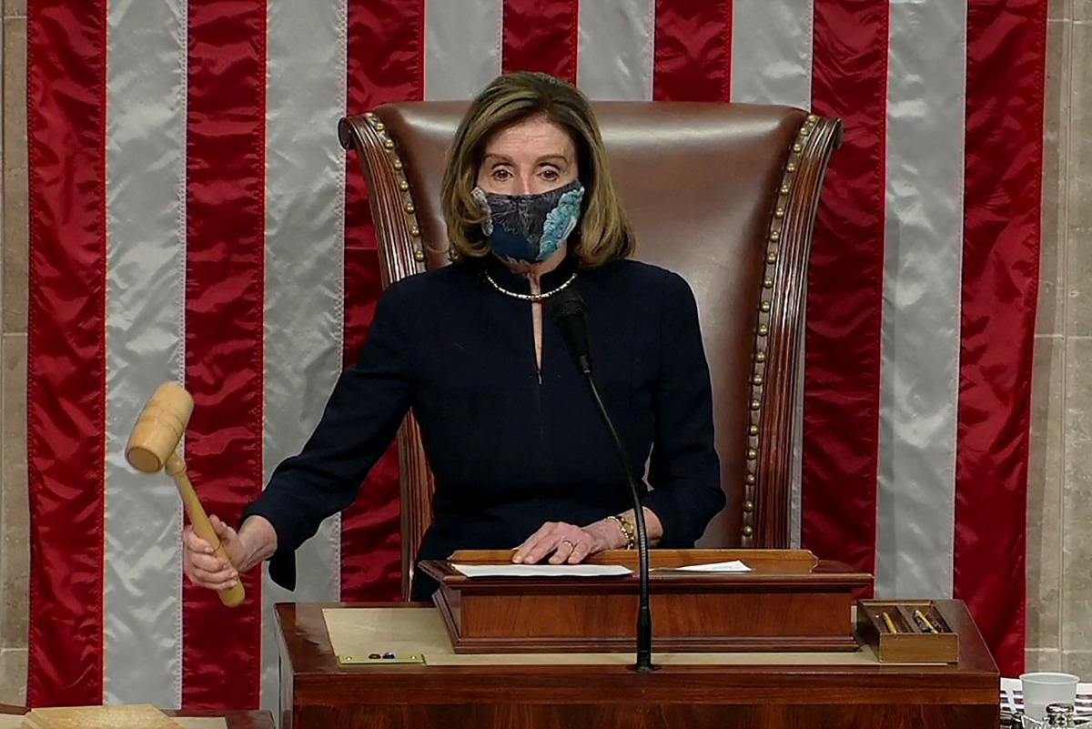 U.S. Speaker of the House Nancy Pelosi (D-CA) wields the gavel as the House of Representatives votes to impeach U.S. President Donald Trump for inciting insurrection, a week after a mob of his supporters stormed the U.S. Capitol, in this frame grab from v