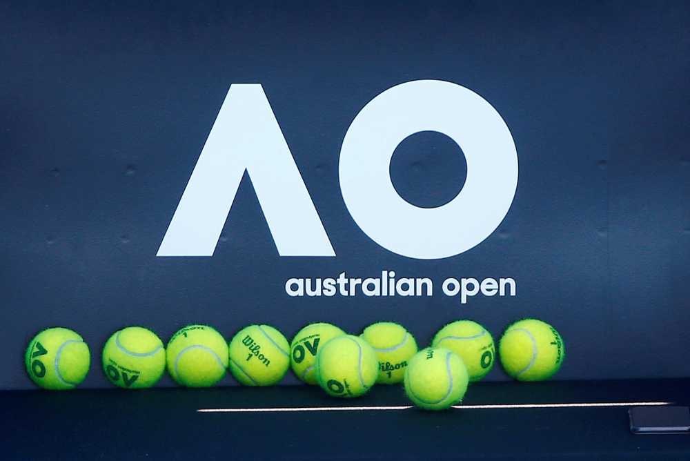 Tennis balls are pictured in front of the Australian Open logo before the tennis tournament. REUTERS/Thomas Peter//File Photo