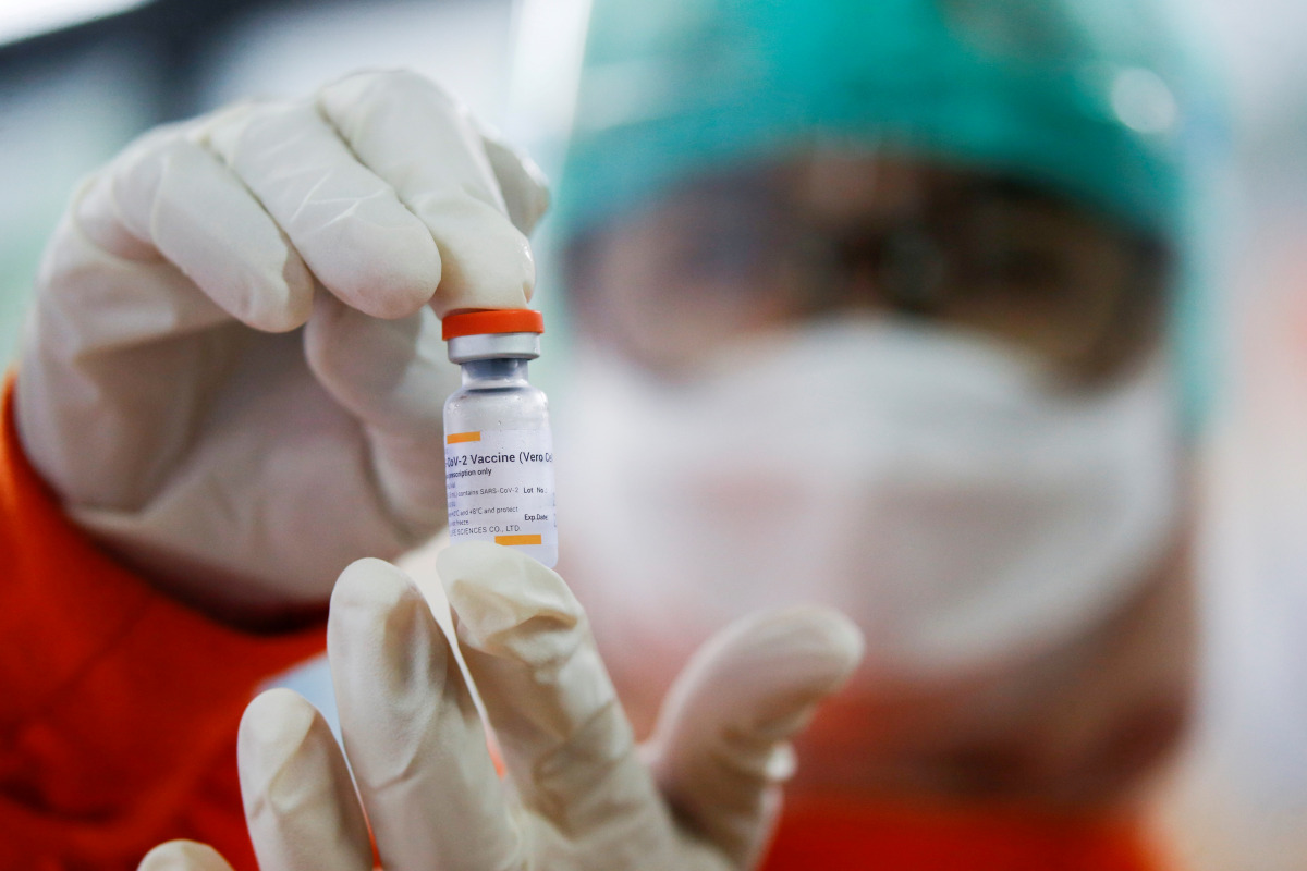 FILE PHOTO: A medical worker holds a dose of the Sinovac's vaccine at a district health facility as Indonesia begins mass vaccination for the coronavirus disease (COVID-19), starting with its healthcare workers, in Jakarta, Indonesia January 14, 2021. REU