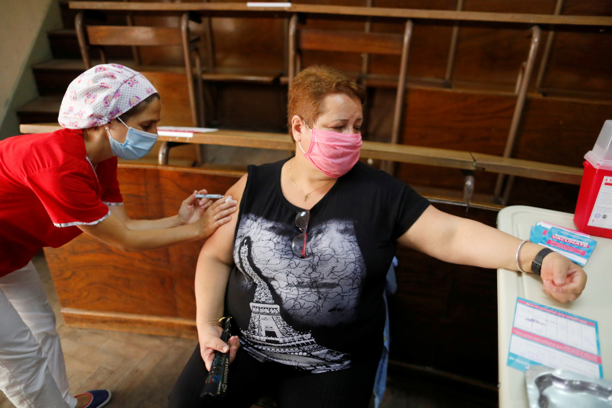 Norma Lopez, 57, gets vaccinated with the Sputnik V (Gam-COVID-Vac) vaccine at the San Martin hospital, in La Plata, on the outskirts of Buenos Aires, Argentina January 18, 2021. REUTERS/Agustin Marcarian
