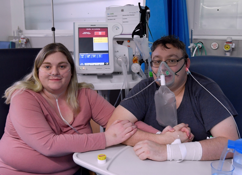 Lizzie Kerr, 31, and Simon O'Brien, 36, embrace in a Covid-19 ward, days after they married in an ICU (Intensive Care Unit) when both had become critically ill with the coronavirus disease, and were uncertain of their chances of surviving, in Milton Keyne