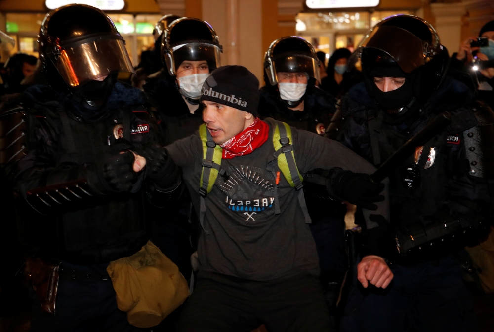 Law enforcement officers detain a man during a rally in support of jailed Russian opposition leader Alexei Navalny in Saint Petersburg, Russia January 23, 2021. REUTERS/Anton Vaganov