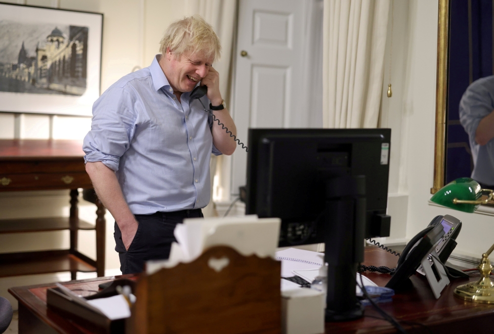 British Prime Minister Boris Johnson speaks to U.S. President Joe Biden from London, Britain, in this social media image obtained on January 23, 2021. Mandatory credit DOWNING STREET HANDOUT /Crown copyright 2021/via REUTERS