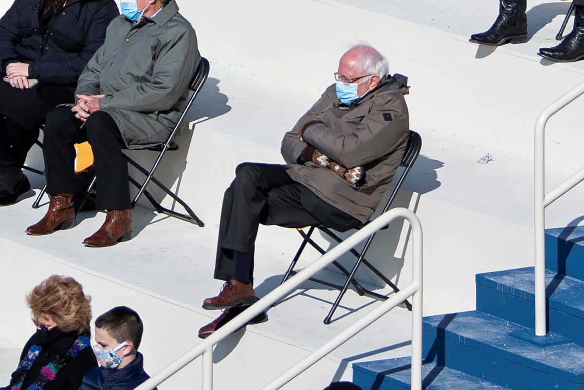 U.S. Senator Bernie Sanders sits socially distanced as he attends the Presidential Inauguration of Joe Biden on the West Front of the U.S. Capitol in Washington, U.S. January 20, 2021. Picture taken January 20, 2021. Caroline Brehman/Pool via REUTERS

