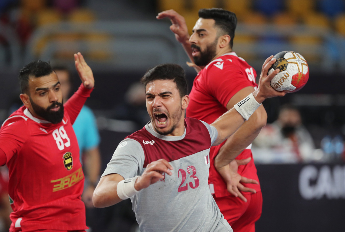 Qatar’s Allaedine Berrached in action with Bahrain’s Mahdi Saad during their match in Cairo on Saturday. 